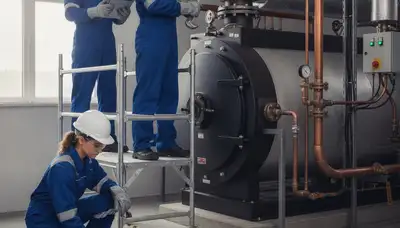 Boiler repair technician servicing a home in Des Moines, IA for reliable winter heating